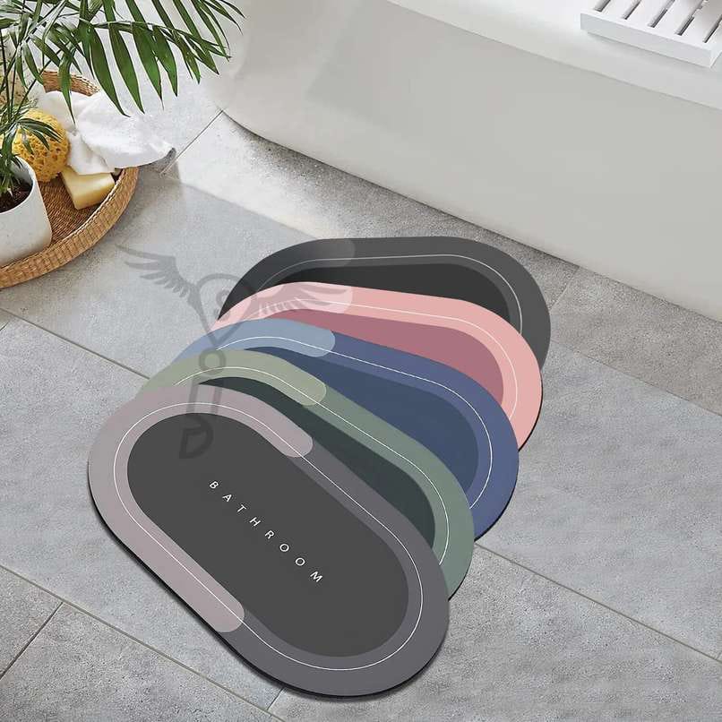 Oval absorbent bath mats in grey, pink, blue and green on a bathroom floor