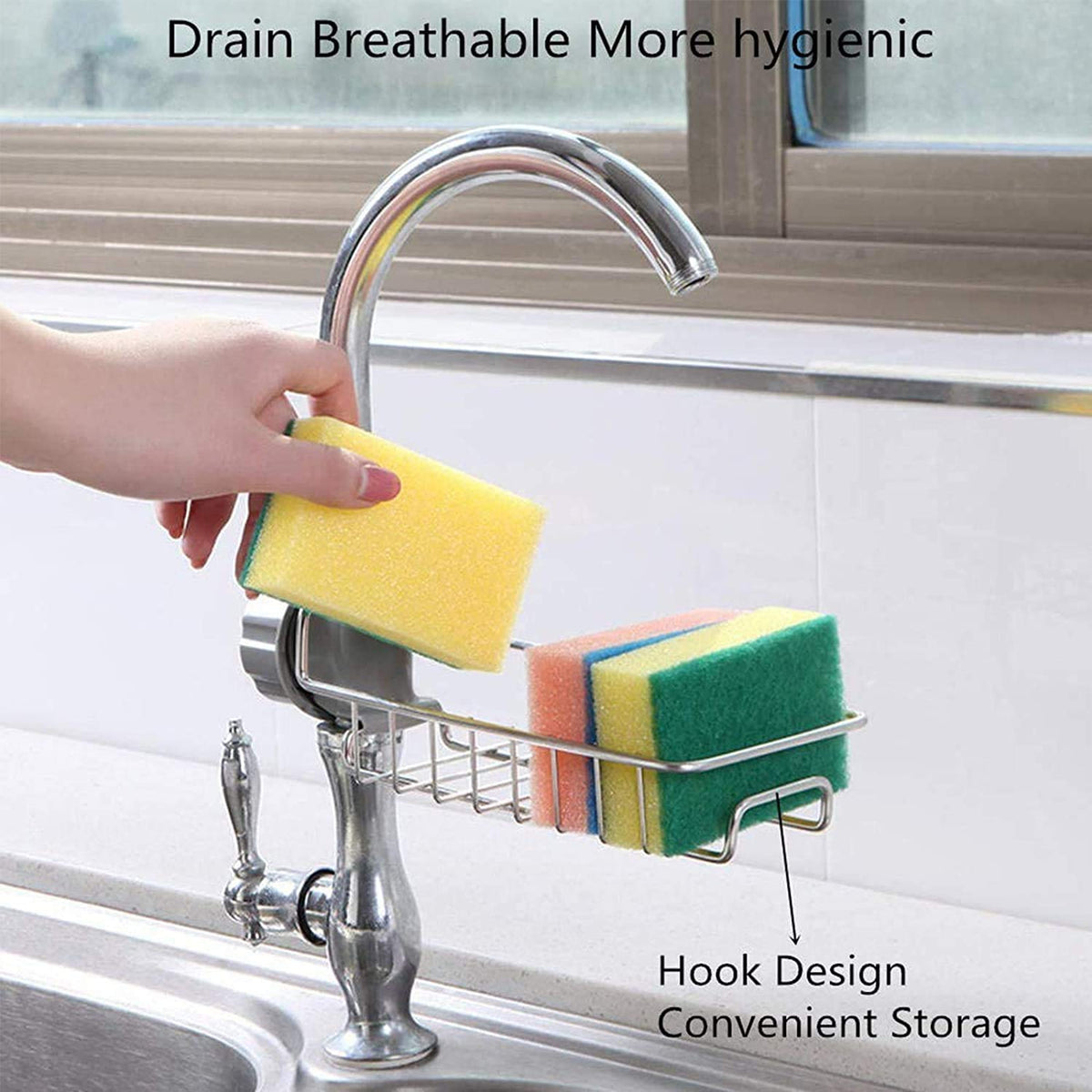 Hand placing a sponge into the steel rack clamped on a kitchen tap, with a hook underneath
