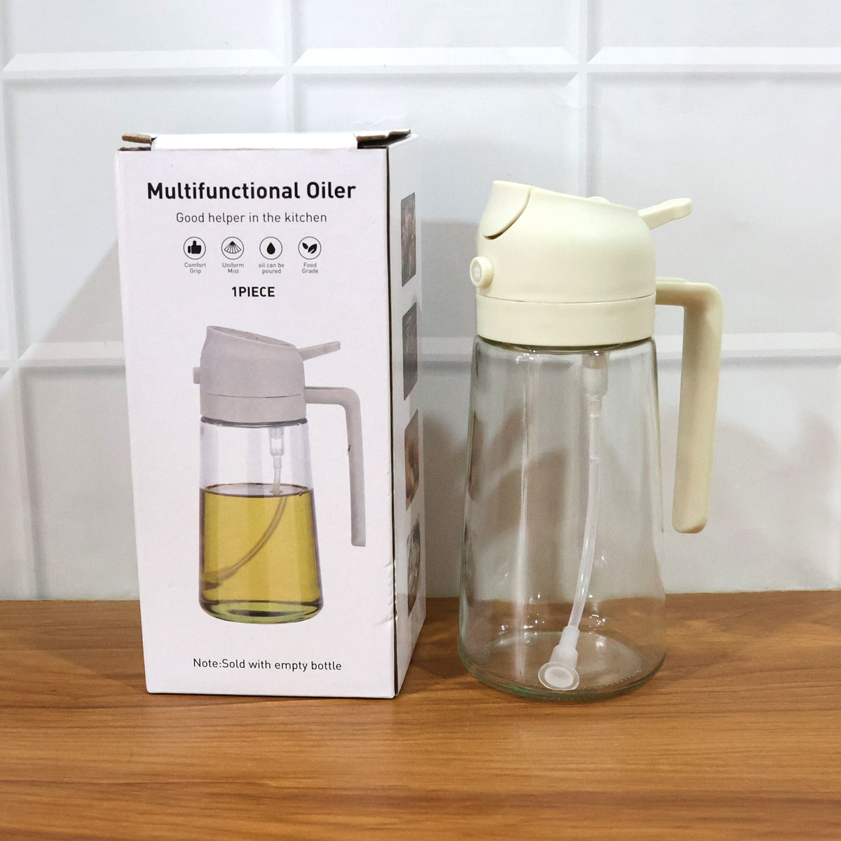 Empty oil bottle next to its box on a kitchen counter