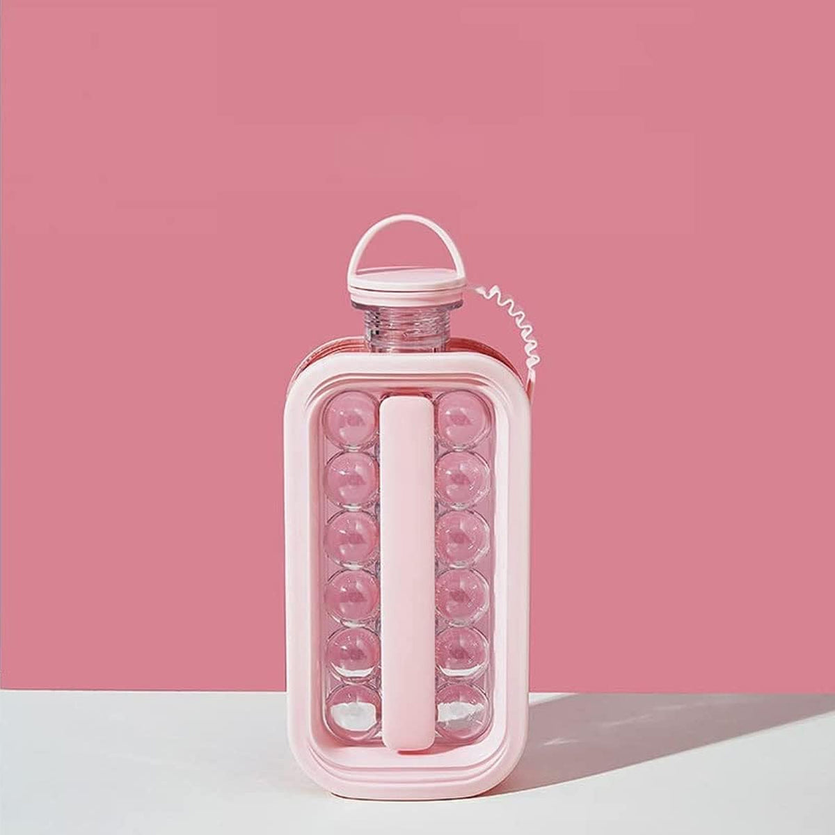 Pink ice ball maker bottle standing on a table