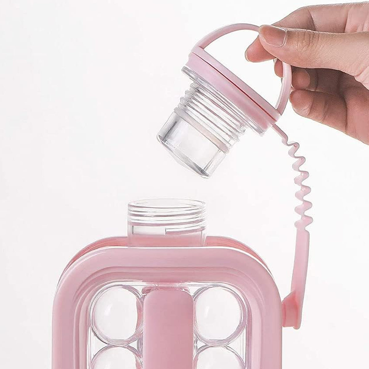 Opening the cap, which stays tied to the bottle with a strap