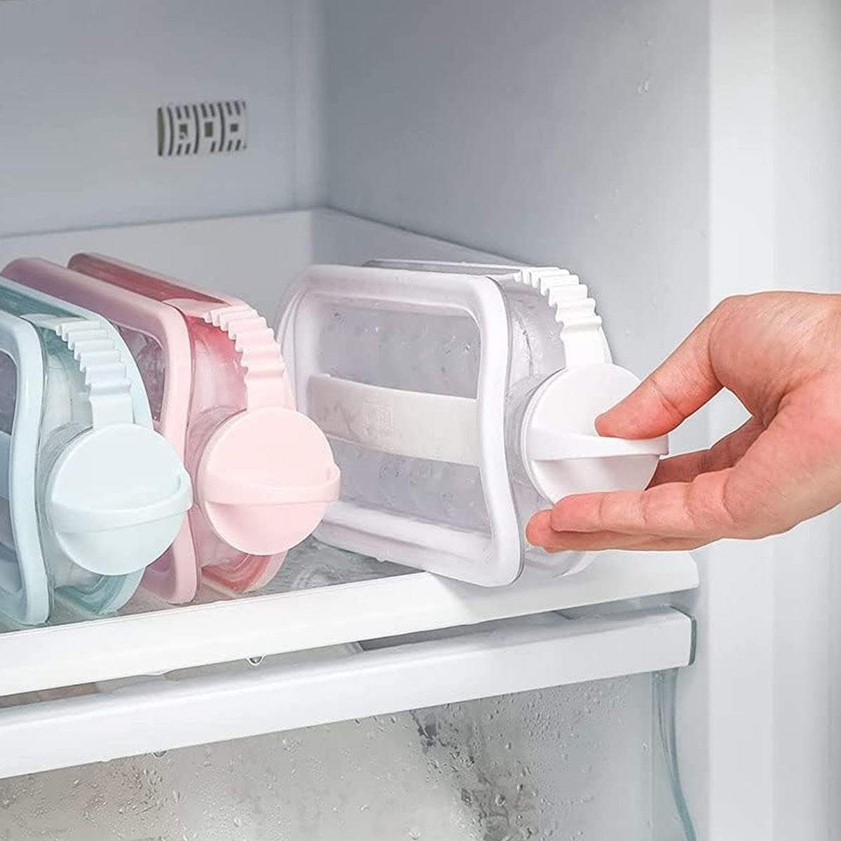 Taking the ice ball maker bottle out of the freezer, lying flat on the shelf