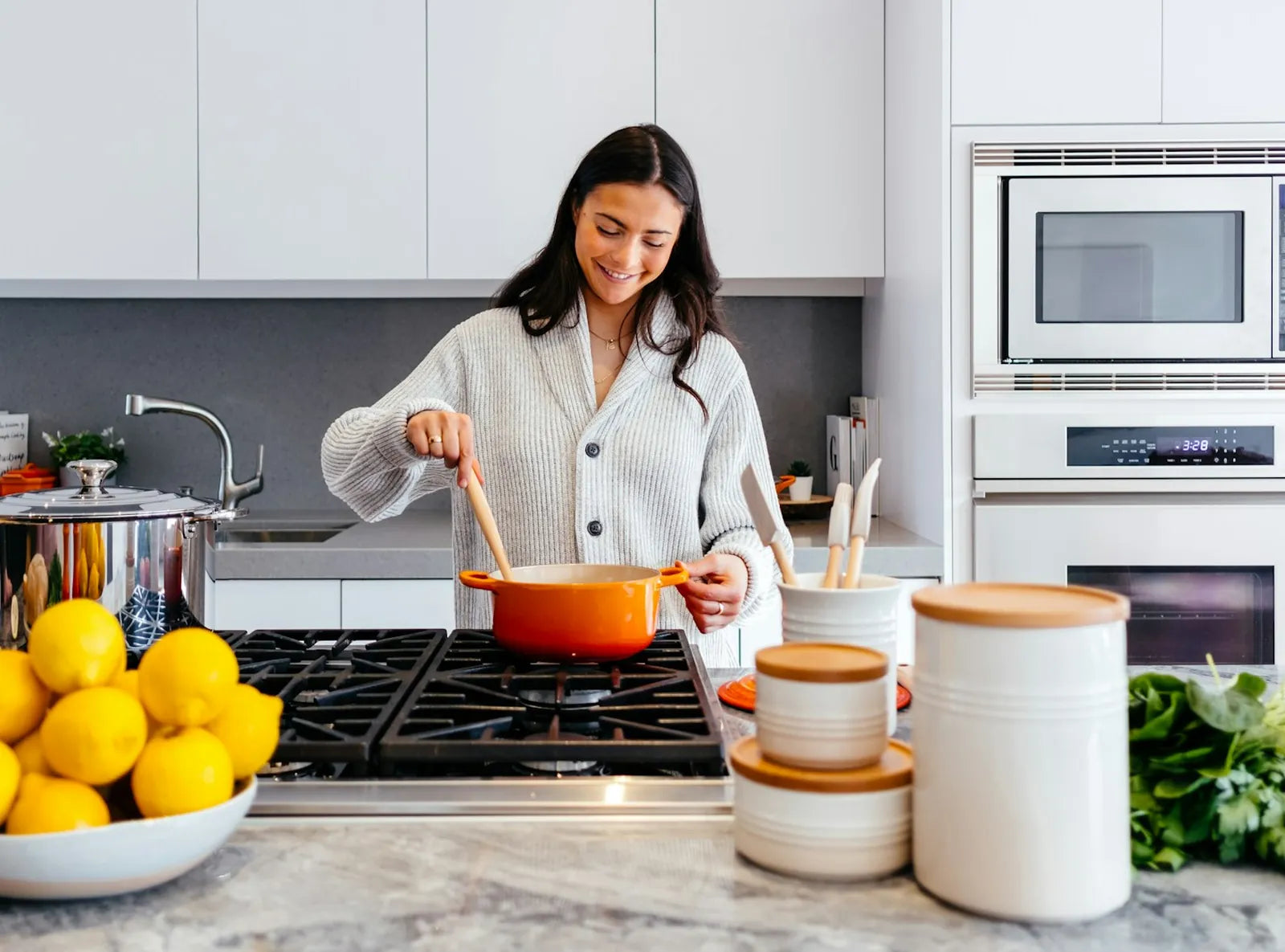 smiling woman cooking in a bright, organised kitchen